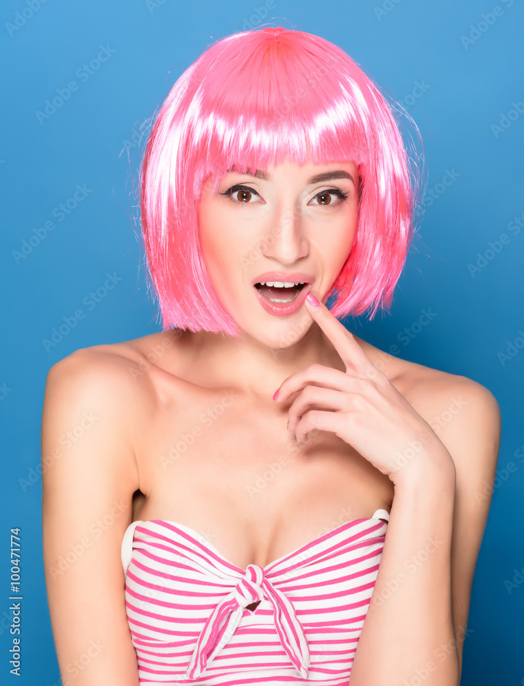 Portrait of beautiful smiling young woman with pink hair on a blue background Portrait of beautiful smiling young woman with pink hair on a blue background