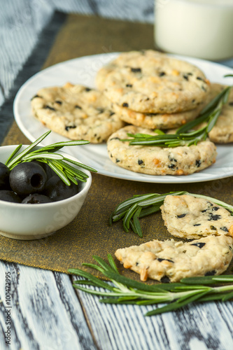 Cookies with cheese  olives and rosemary on napkin