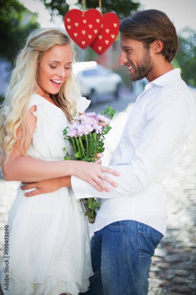 Composite image of attractive couple with bunch of flowers Composite image of attractive couple with bunch of flowers