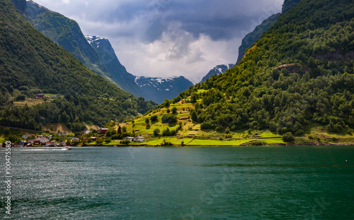 Norway. The village on the bank of the fjord lit with the sun af