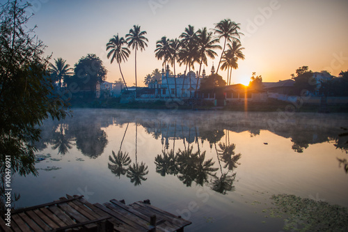 Palm trees reflected in Nam Pilu river at dawn, Loikaw