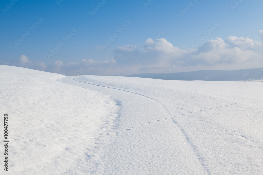 Winter road under blue sky