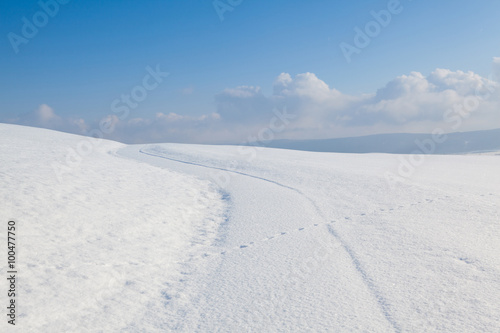 Winter road under blue sky