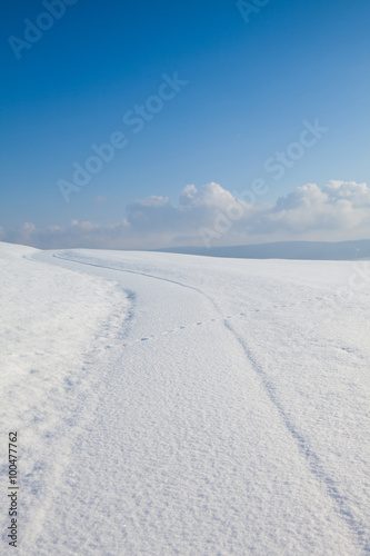 Winter road under blue sky © Radomir Rezny