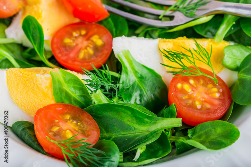 Fresh green salad with lamb's lettuce, cherry tomatoes and eggs photo