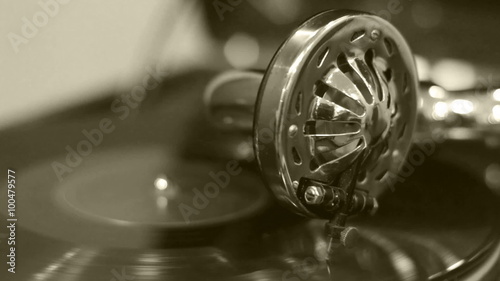 Old gramophone playing music (no audio) in sepia