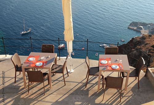 Alfresco cafe on terrace over sea coast, Santorini, Greece