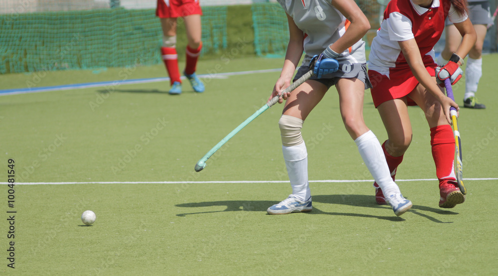 Women field hockey players with ball