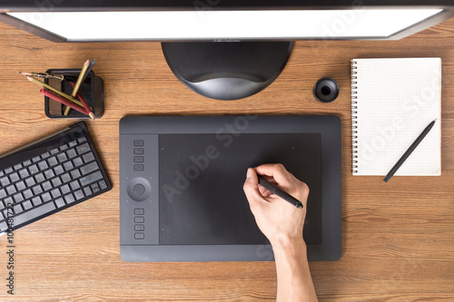 Designer workspace with tablet, keyboard, computer photo