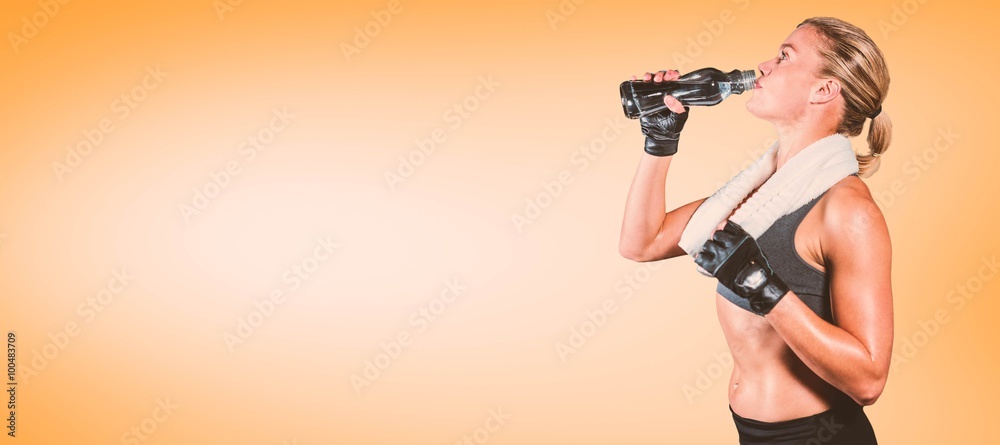 Composite image of muscular woman drinking water Composite image of muscular woman drinking water