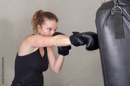 Young blonde woman in a boxing gym for a workout © edojob