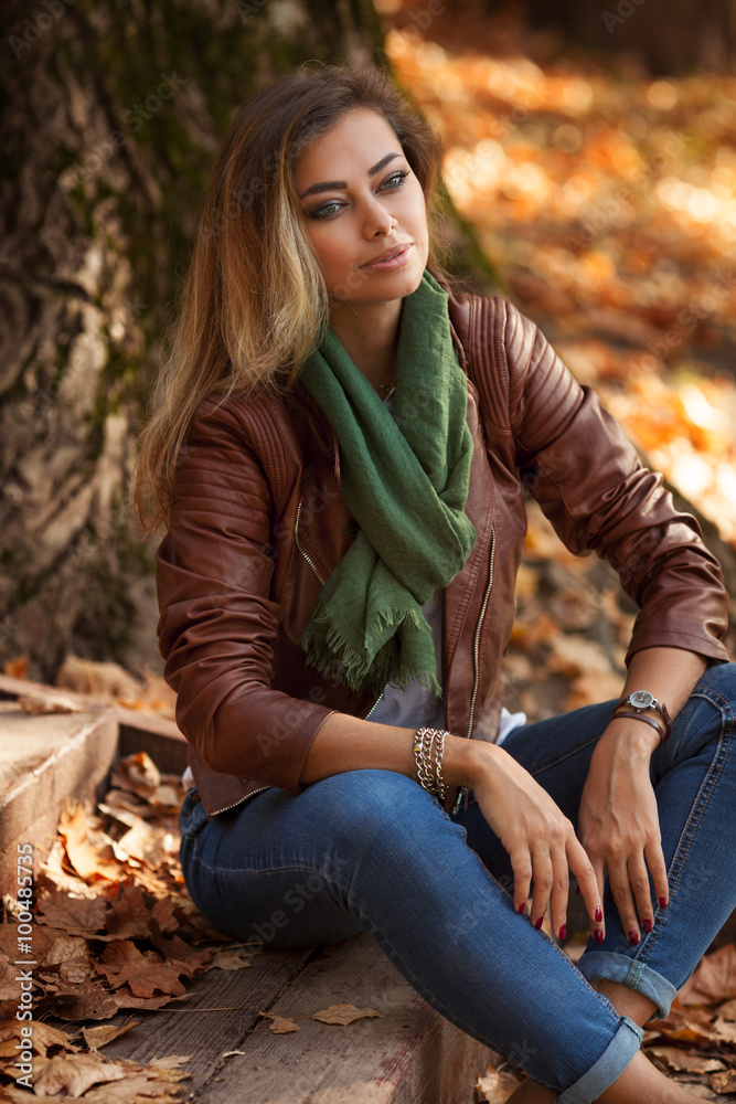 Beautiful young blond woman in a park relaxing Beautiful young blond woman in a park relaxing