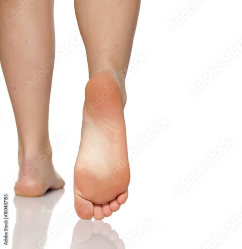 bare female feet on a white floor © vladimirfloyd