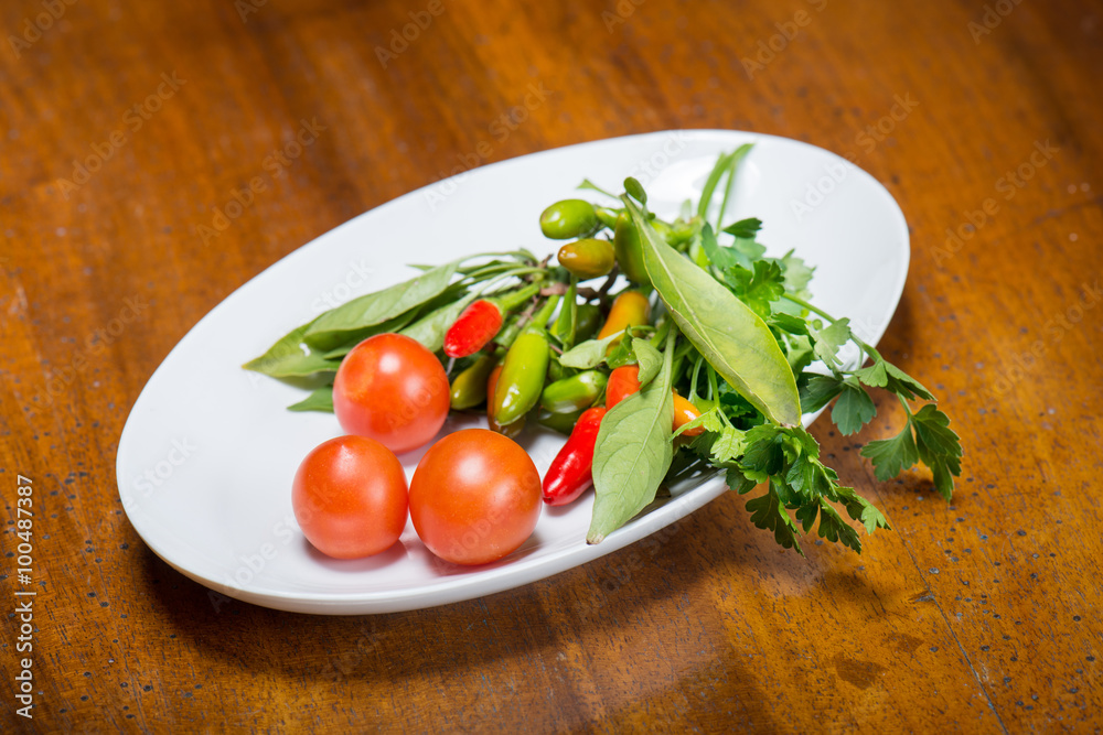 Tomatoes and hot peppers with parsley fresh from the garden Tomatoes and hot peppers with parsley fresh from the garden