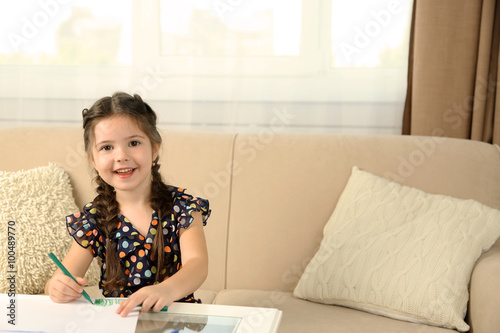 Cute little girl drawing pi...