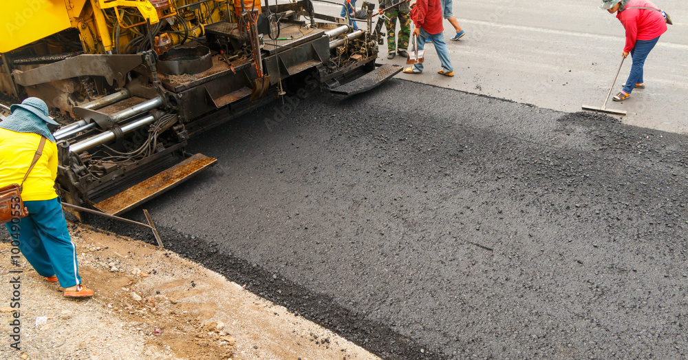 Asphalt spreader in work on site.