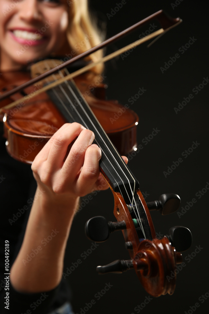 Musician plays violin on black background, close up Musician plays violin on black background, close up