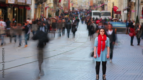Young woman posing, busy street, people walking around, 4K