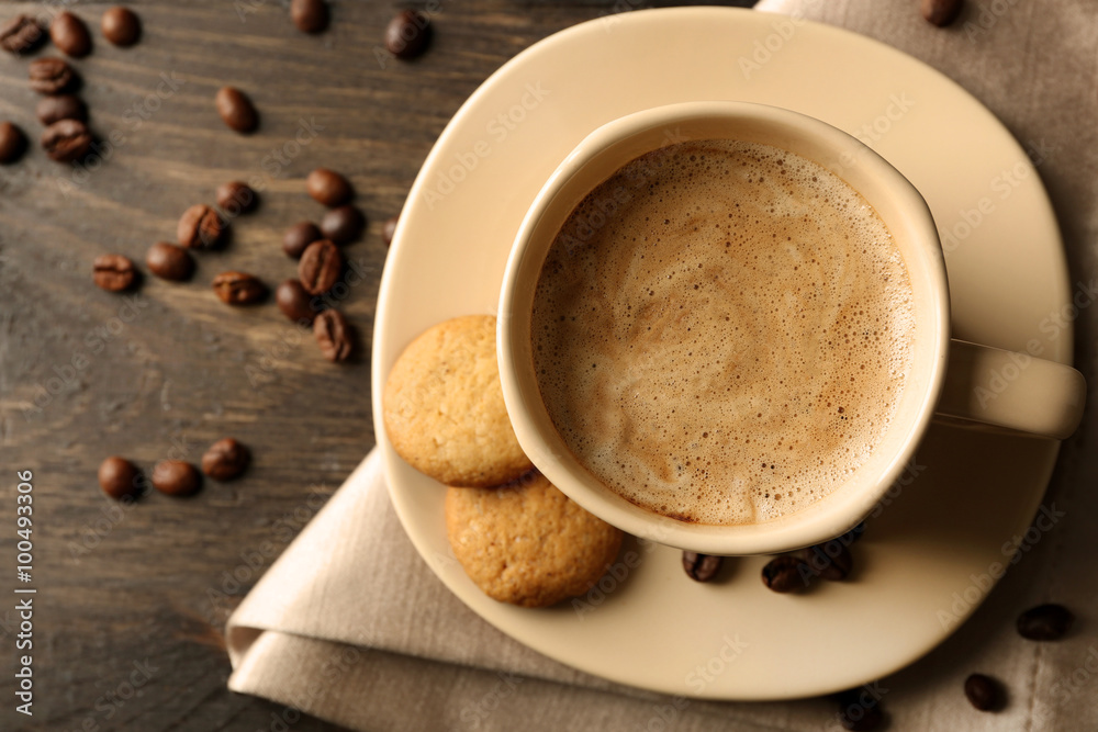 Cup of coffee on wooden table background