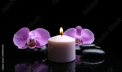 Composition of orchid  pebbles and candle on dark background