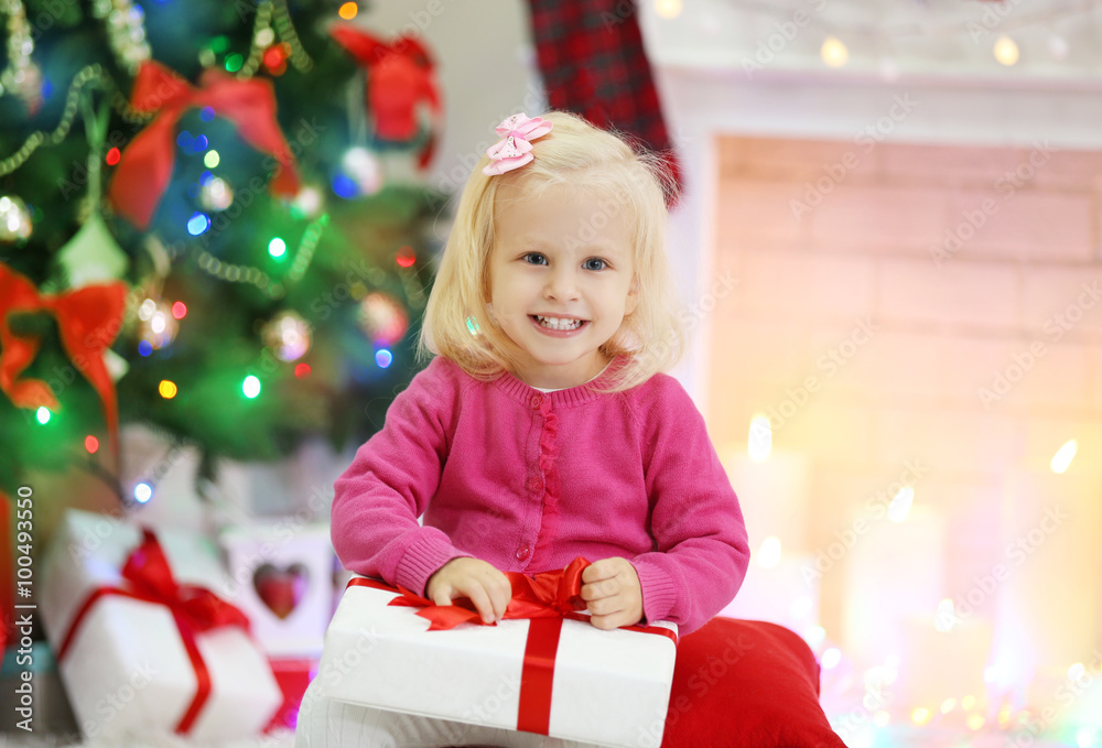 Funny girl with gift boxes and Christmas tree on background Funny girl with gift boxes and Christmas tree on background