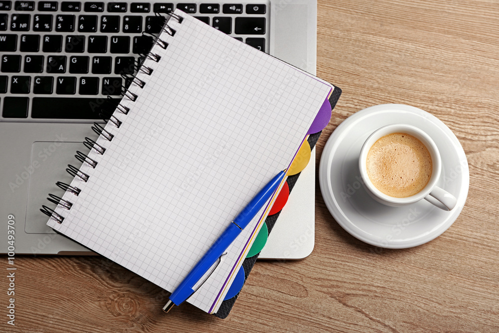 Empty notebook on laptop keyboard, on light background Empty notebook on laptop keyboard, on light background