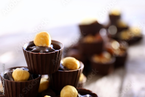 Composition of different chocolate candies on wooden background, close up