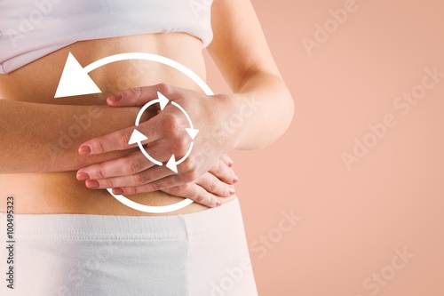 Composite image of slim woman touching her belly photo