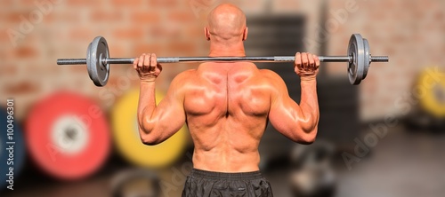 Composite image of rear view of bodybuilder lifting crossfit