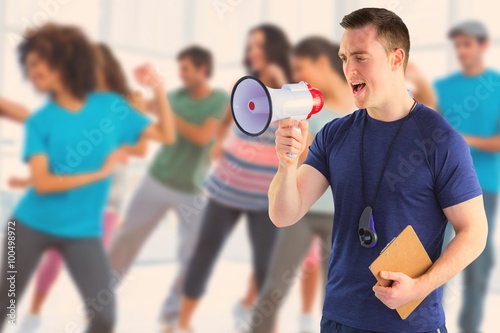 Composite image of male trainer yelling through the megaphone photo