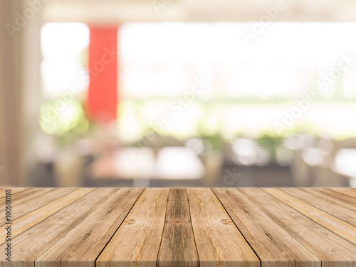 Wooden board empty table in front of blurred background. Perspective brown wood over blur in coffee shop - can be used for display or montage your products.Mock up your products.Vintage filter.
