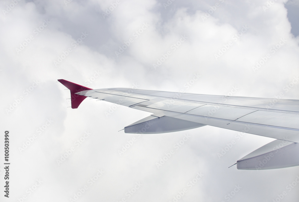 Wing of an airplane in cloudy, View of jet plane wing Wing of an airplane in cloudy, View of jet plane wing