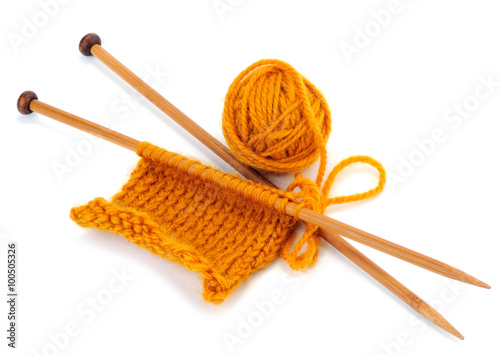 Yellow yarn of knitting with needles and ball