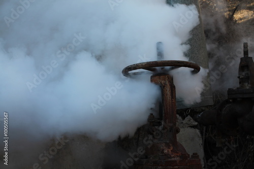 Steam escapes from the valve installed on the pipeline