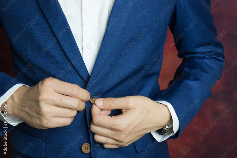 man in blue suit, doing button