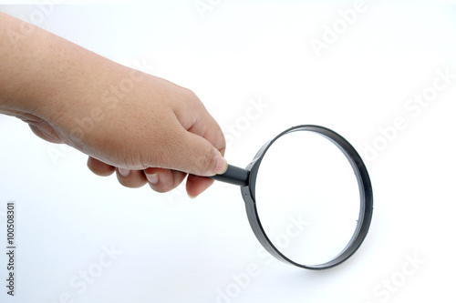 Magnifier in hand on white background
