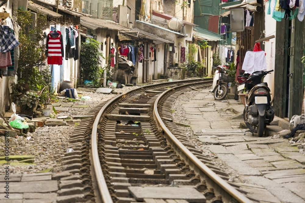 train passing through streets of hanoi slums, vietnam