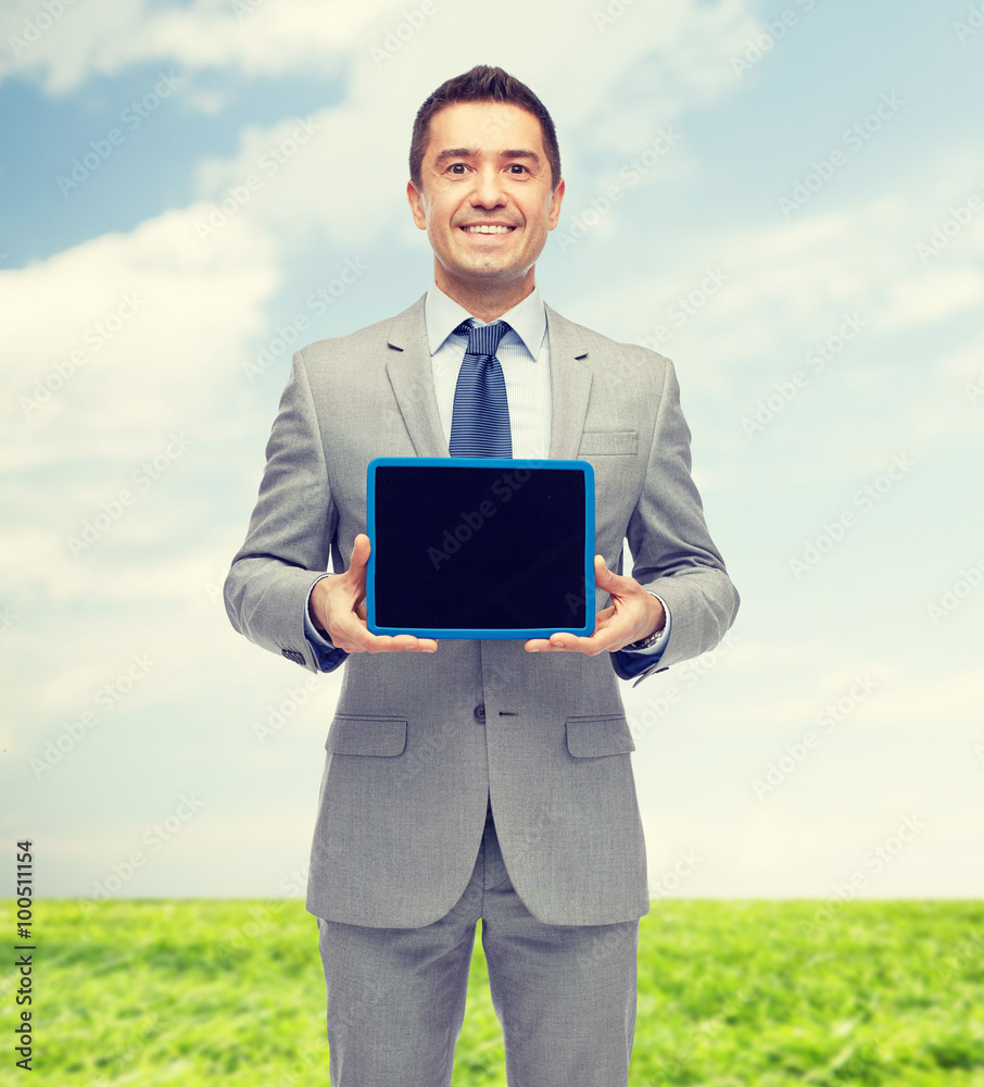 happy businessman in suit showing tablet pc screen