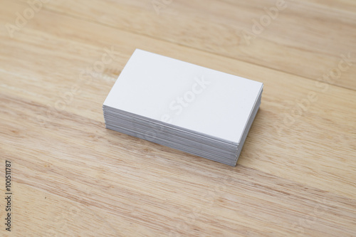 blank business cards stack up on wooden table