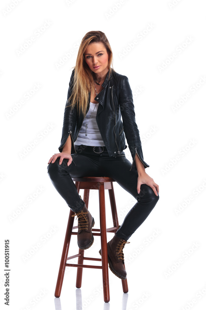 girl in boots and leather jacket pose seated in white studio bac girl in boots and leather jacket pose seated in white studio bac