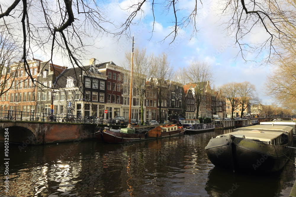 View of Amsterdam canal, typical dutch houses and boats, Holland, Netherlands.