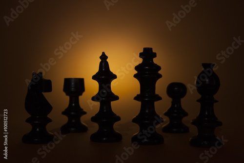 Team work concept with chess pieces in silhouette