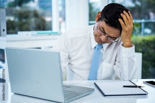 Worried businessman working at his desk