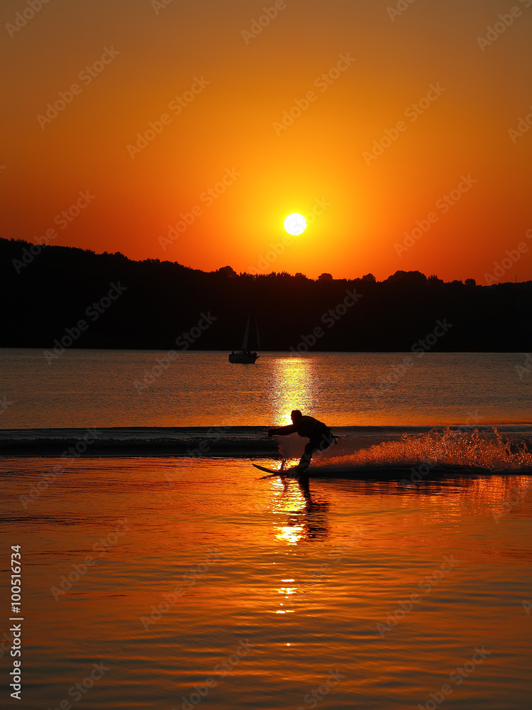 silhouette of man on water skis at sunset silhouette of man on water skis at sunset