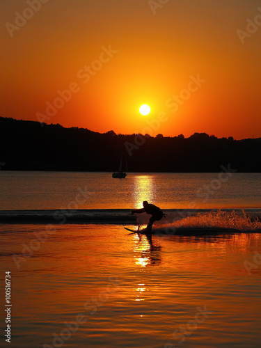 silhouette of man on water skis at sunset