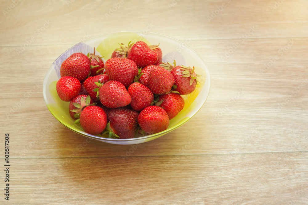 Plate with strawberries clouse up on a light blurred background. Plate with strawberries clouse up on a light blurred background.