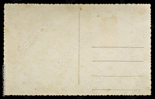 Old paper postcard with decorative fluted edges isolated on black background