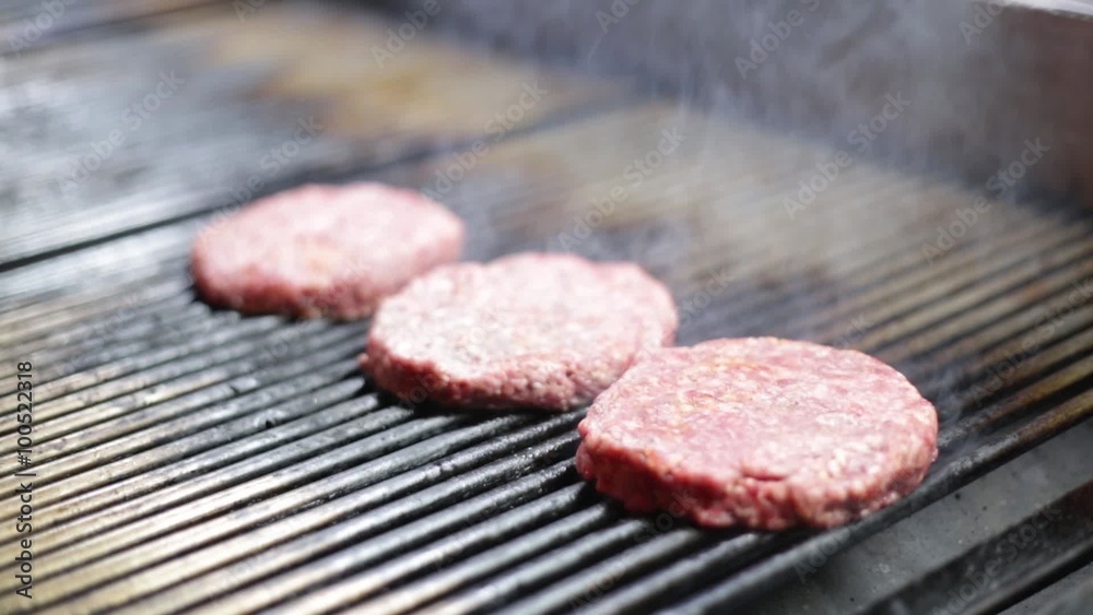 Meat balls being prepared on a grill with fire Meat balls being prepared on a grill with fire