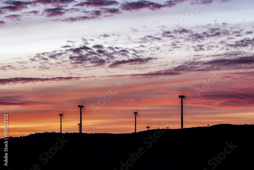 Silhouettes of windmills at dawn