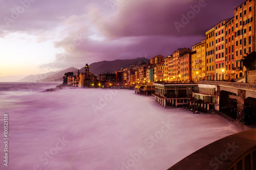 Camogli seafront at sunset with purple reflections on the water